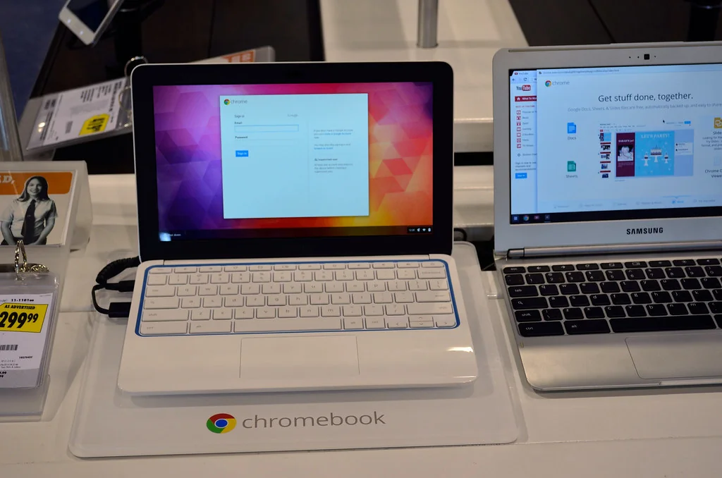 Two Chromebooks on display, one showing Google Docs and Sheets