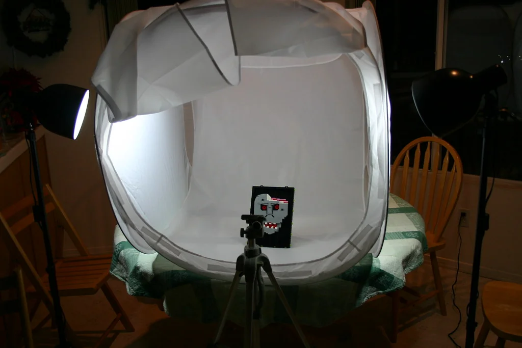 Photo light box with lamps and a tripod set up for product photos